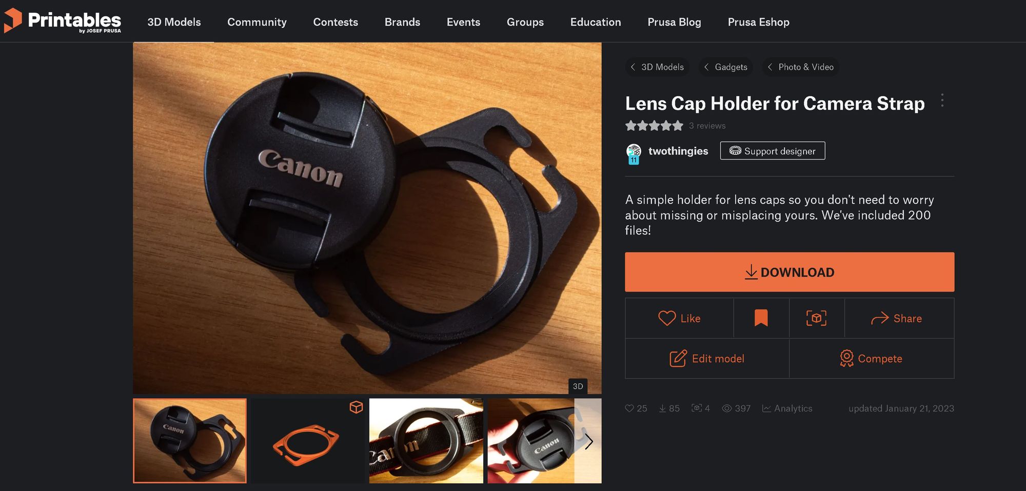 A screenshot of Printables.com showing the lens cap holder published by TwoThingies